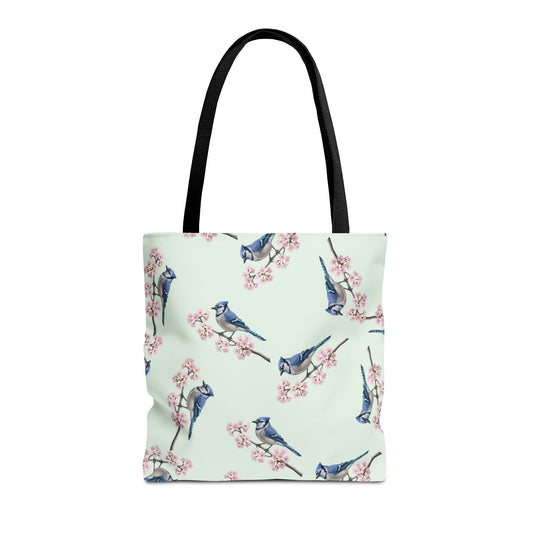 Tote bag with blue jay bird and cherry blossom pattern on a light green background