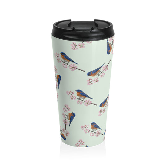 A premium 15oz stainless steel travel tumbler in sage green, featuring a seamless pattern of a Bluebird and cherry blossoms, with a black spill-proof lid. High-quality birdwatching coffee mug in e-commerce.
