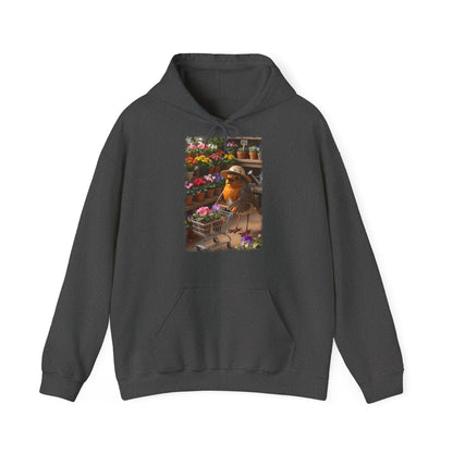 Digital gemalte Illustration eines glücklichen Rotkehlchens mit Sonnenhut, das an einer Blume schnuppert und einen vollen Einkaufswagen schiebt, gedruckt mit weichen Acryl-Kanten auf einem gemütlichen Unisex-Hoodie.