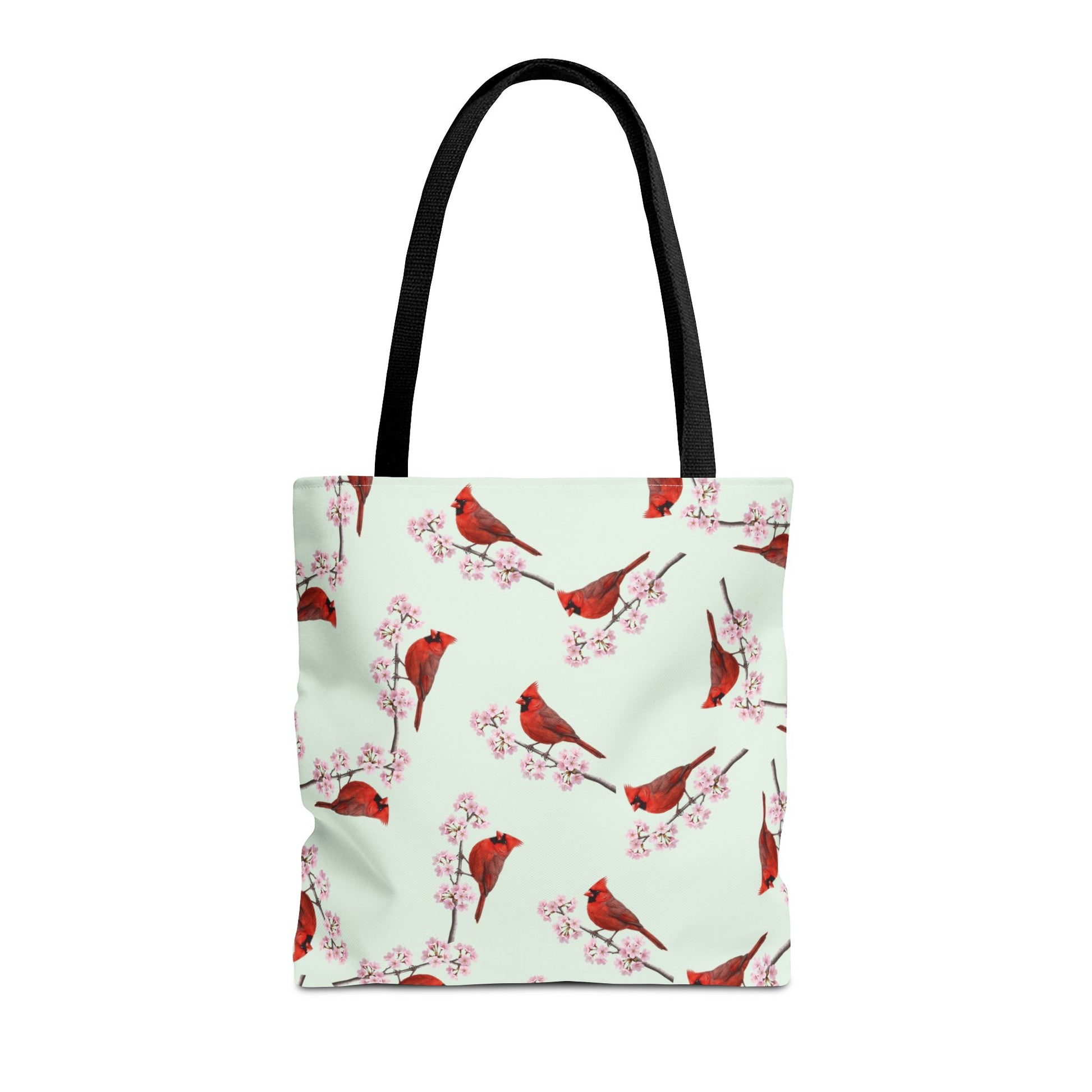 Tote bag with red cardinal bird and cherry blossom pattern on a light green background