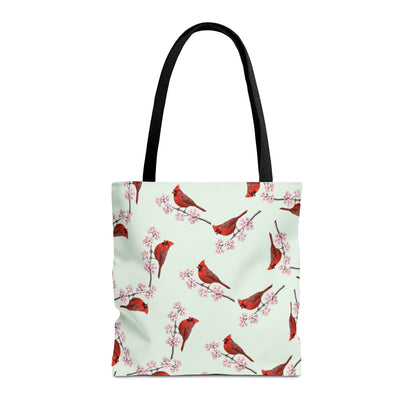 Tote bag with red cardinal bird and cherry blossom pattern on a light green background