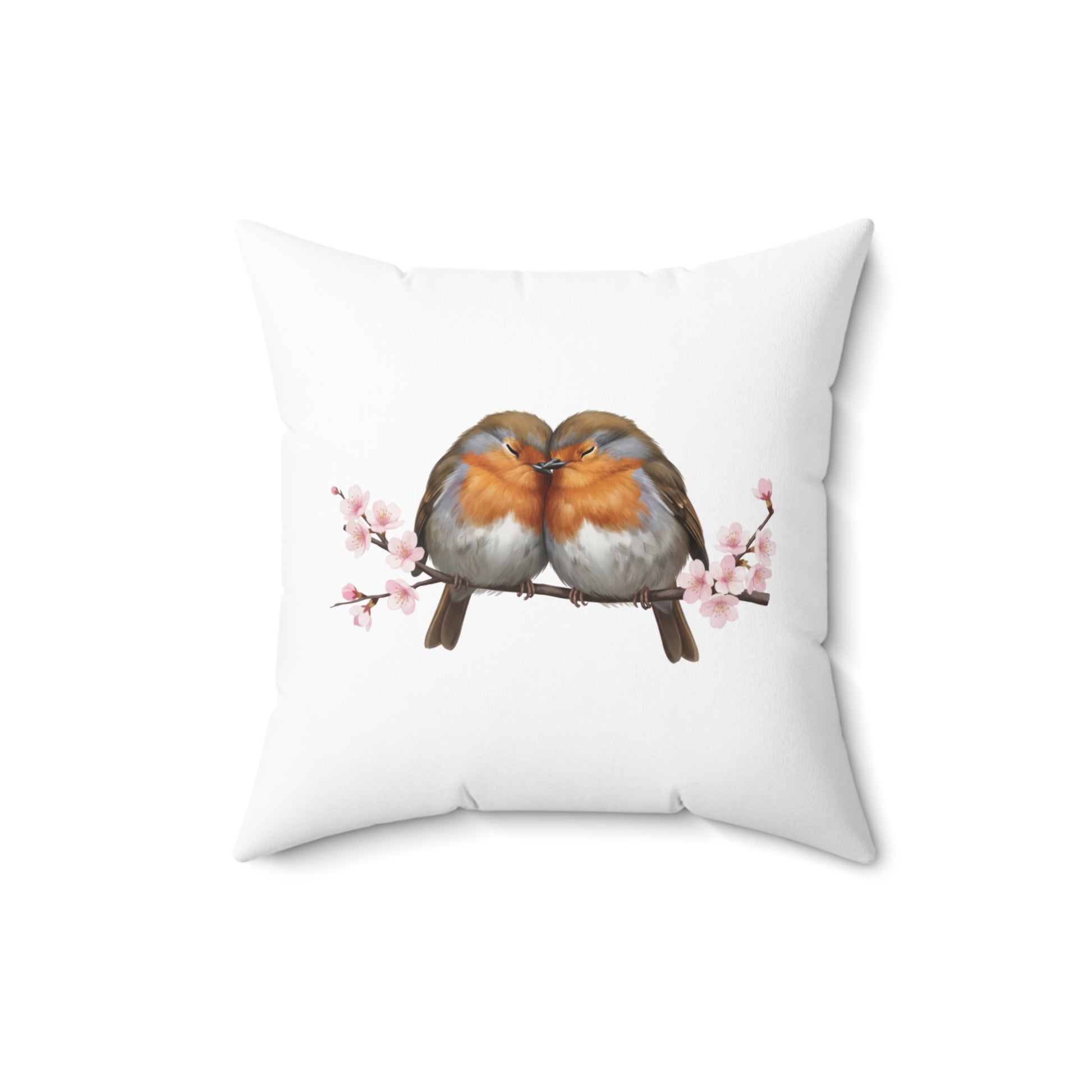 Decorative pillow with two birds on a branch and cherry blossoms on a white background