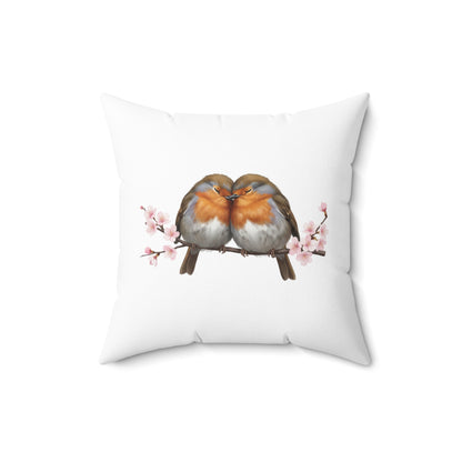 Decorative pillow with two birds on a branch and cherry blossoms on a white background