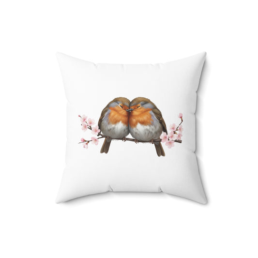 Decorative pillow with two birds on a branch and cherry blossoms on a white background