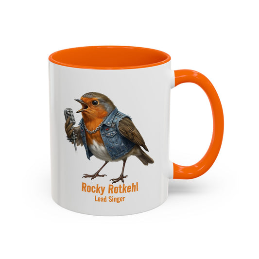 Mug with a robin illustration holding a microphone, wearing a denim jacket, and text 'Rocky Rotkehl Lead Singer' on a white background.