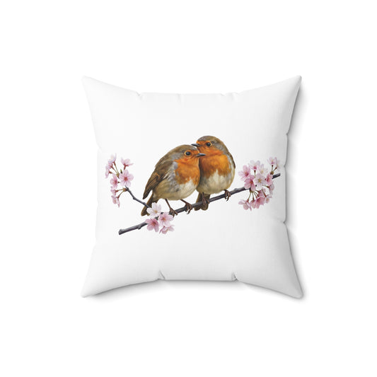 weißes kissen mit zwei gemalten rotkehlchen die auf einem ast mit kirschblueten sitzen