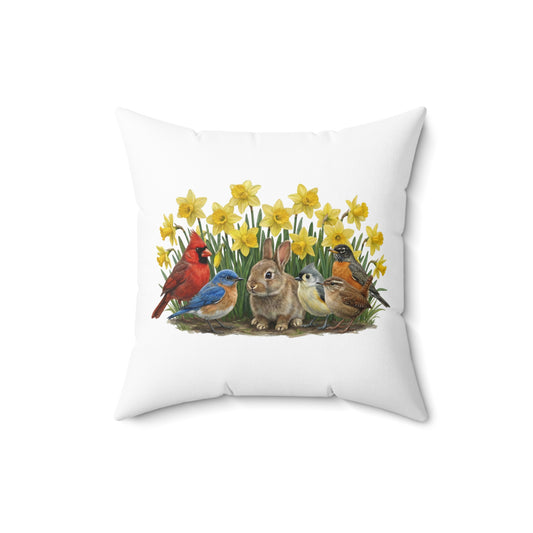 Decorative pillow with a design of birds and a rabbit among daffodils on a white background