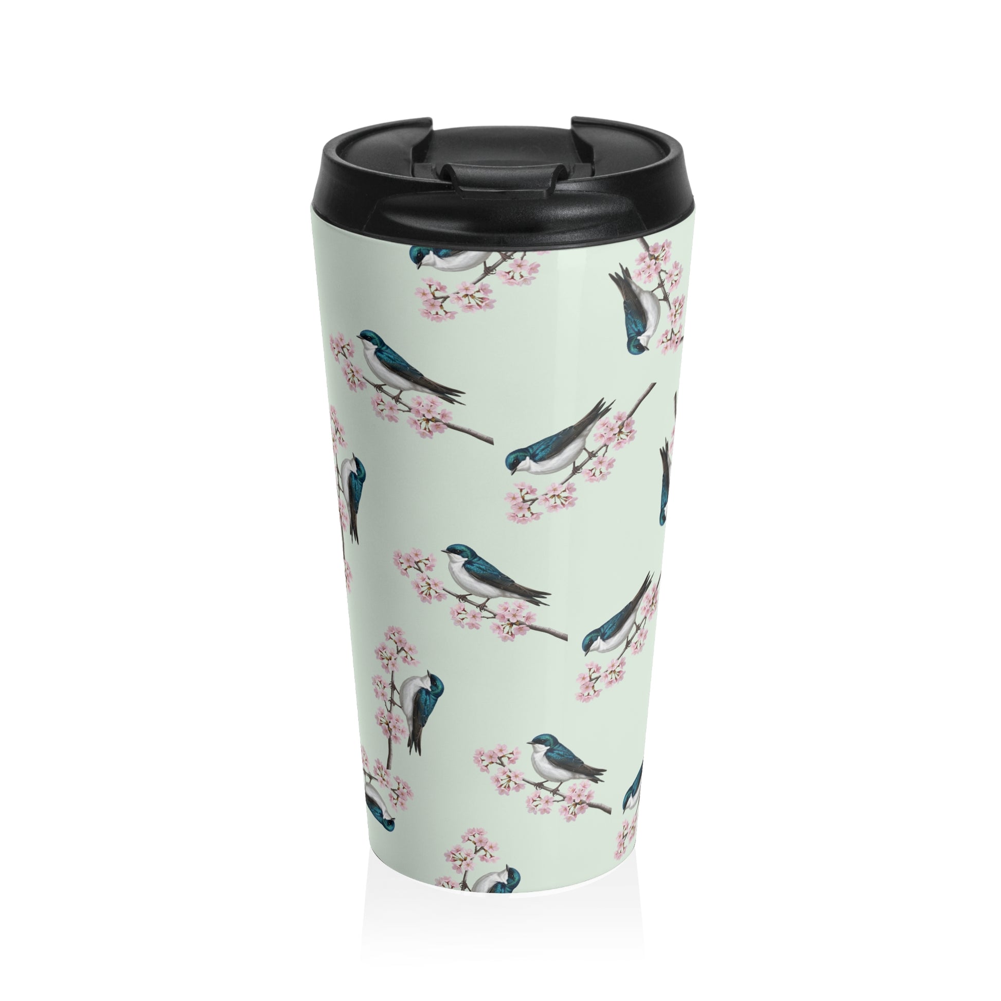 A premium 15oz stainless steel travel tumbler in sage green, featuring a seamless pattern of a Tree Swallow and cherry blossoms, with a black spill-proof lid. High-quality birdwatching coffee mug in e-commerce.