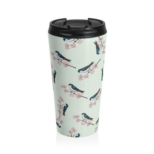 A premium 15oz stainless steel travel tumbler in sage green, featuring a seamless pattern of a Tree Swallow and cherry blossoms, with a black spill-proof lid. High-quality birdwatching coffee mug in e-commerce.