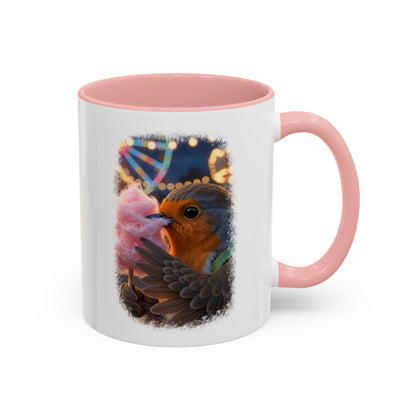 Weiße Keramiktasse mit rosa Henkel und Innenseite. Das aufgedruckte Motiv zeigt eine digitale Illustration von einem niedlichen Rotkehlchen namens Rosi, das glücklich in eine riesige rosa Zuckerwatte beißt.