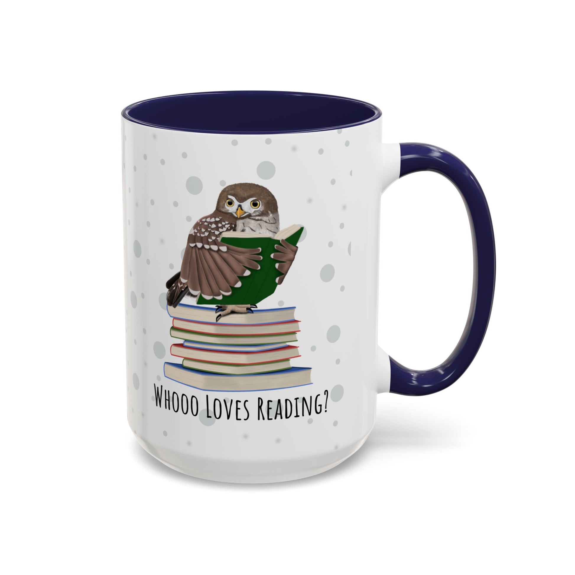 A white ceramic mug with a dark navy blue interior and handle, featuring a printed illustration of an owl perched on a stack of books and the text 'WHOOO LOVES READING?'.